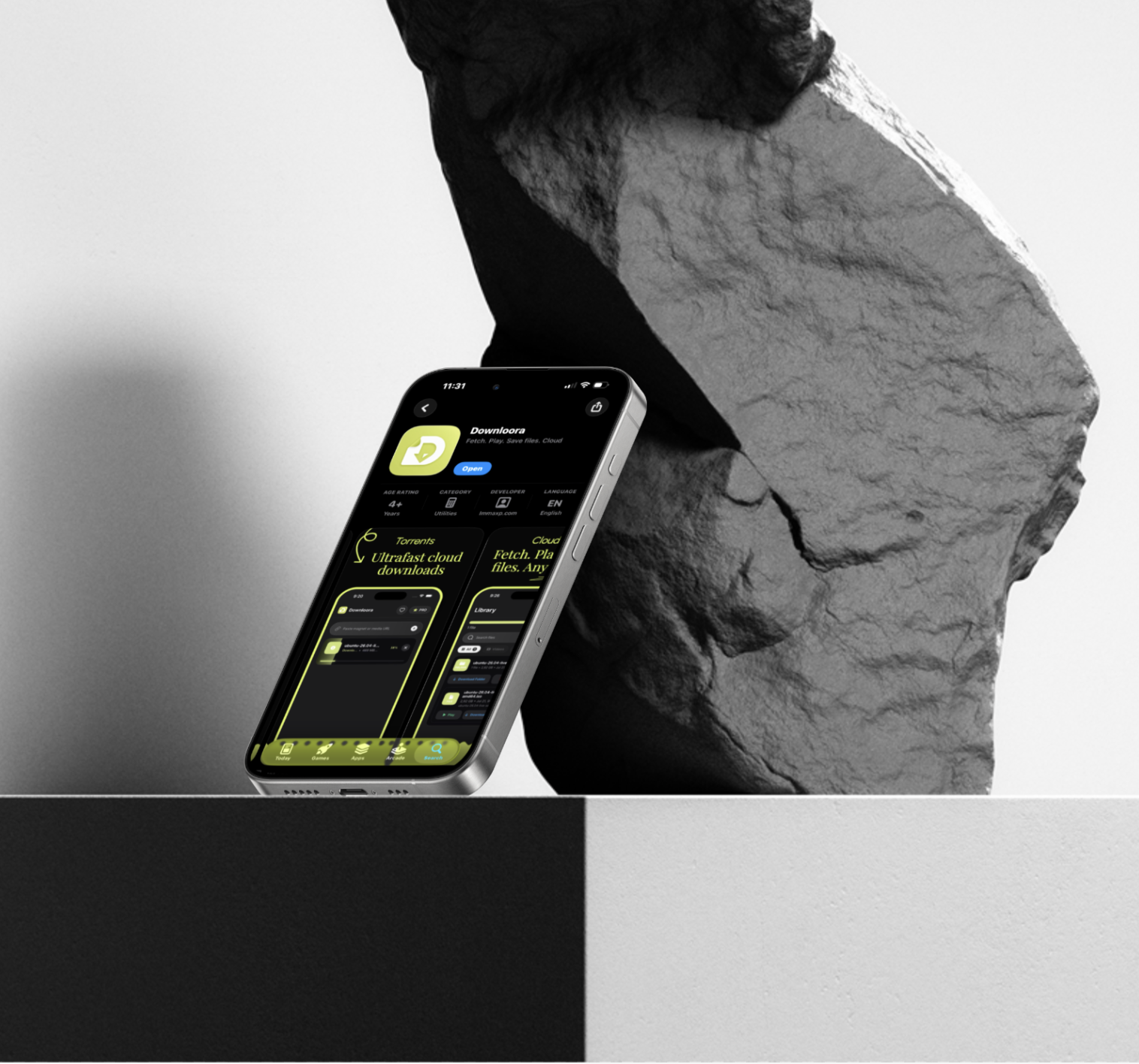 Downloora on an iPhone beside a sculptural stone backdrop