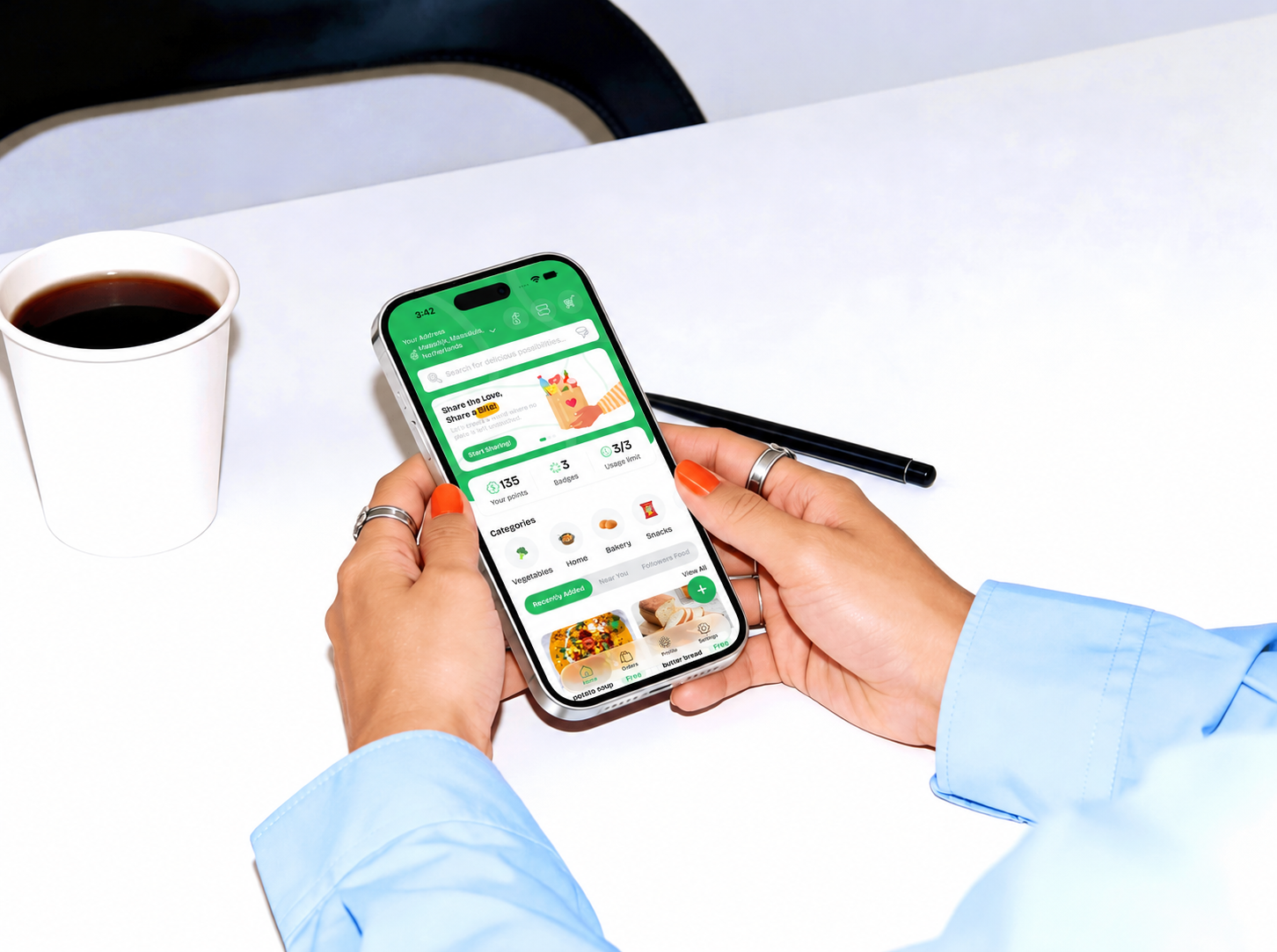 Foosh on an iPhone beside a cup of coffee