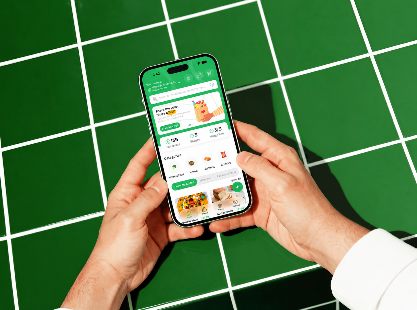 Foosh on an iPhone held above green tiles